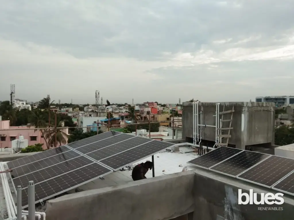 Twin rows of solar panels on a terrace near Sriperumbudur