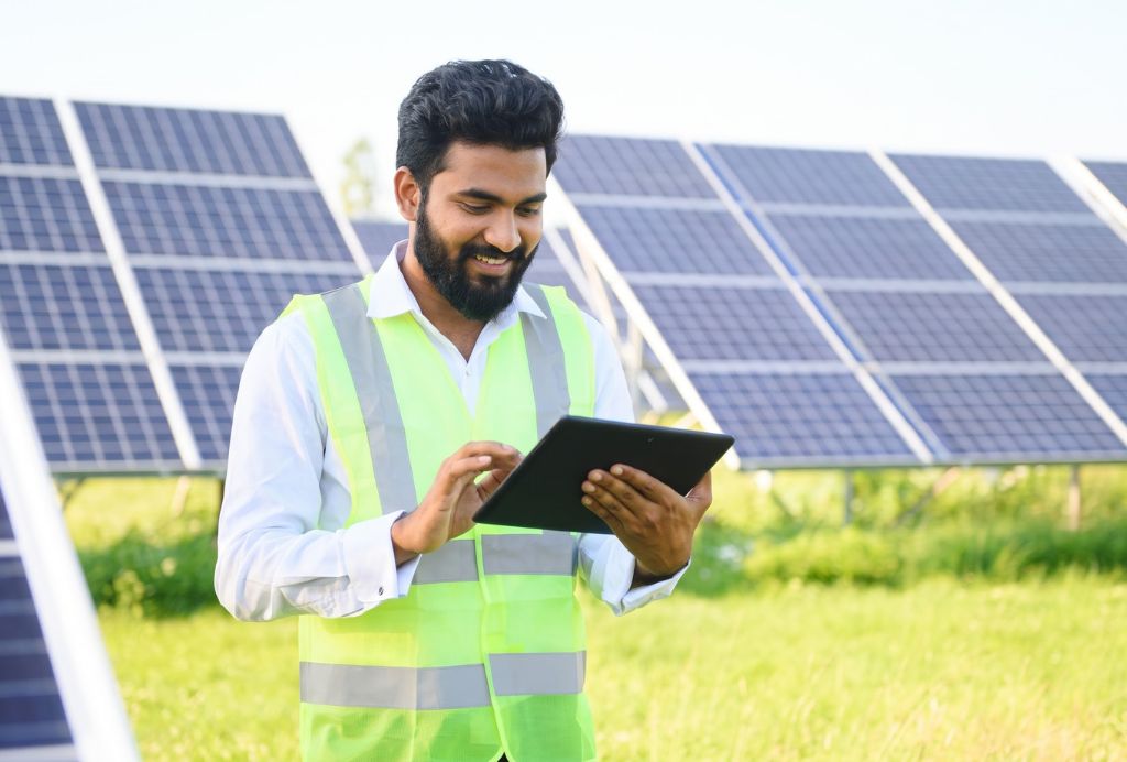 Solar engineer checking generation figures on a tablet