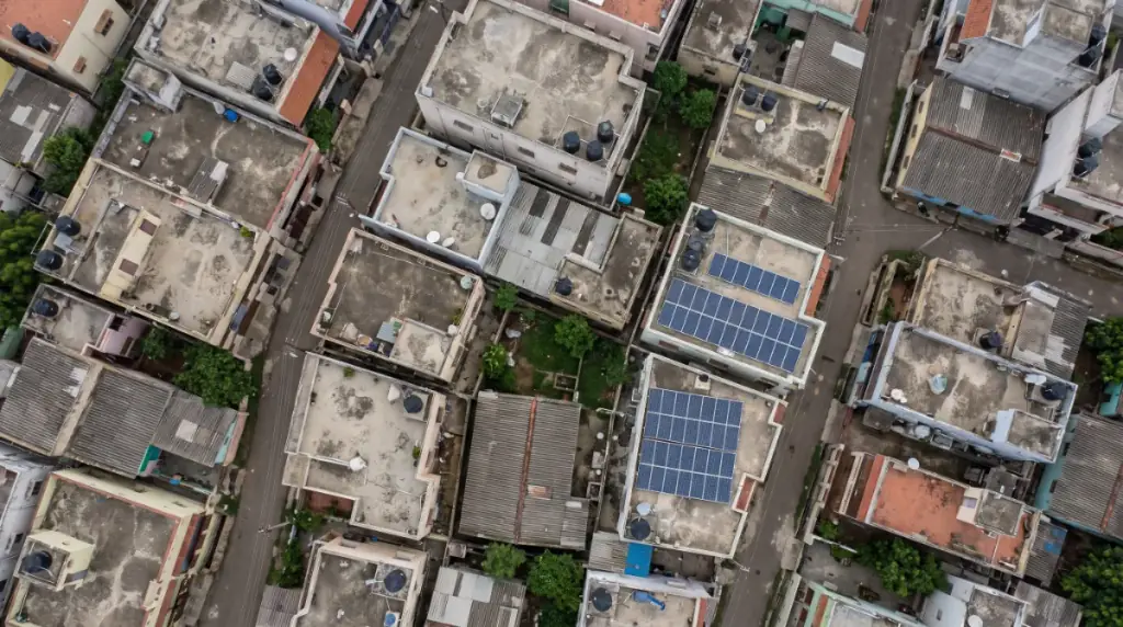 Aerial view of rooftops in Sunguvarchatram with solar panels on several terraces