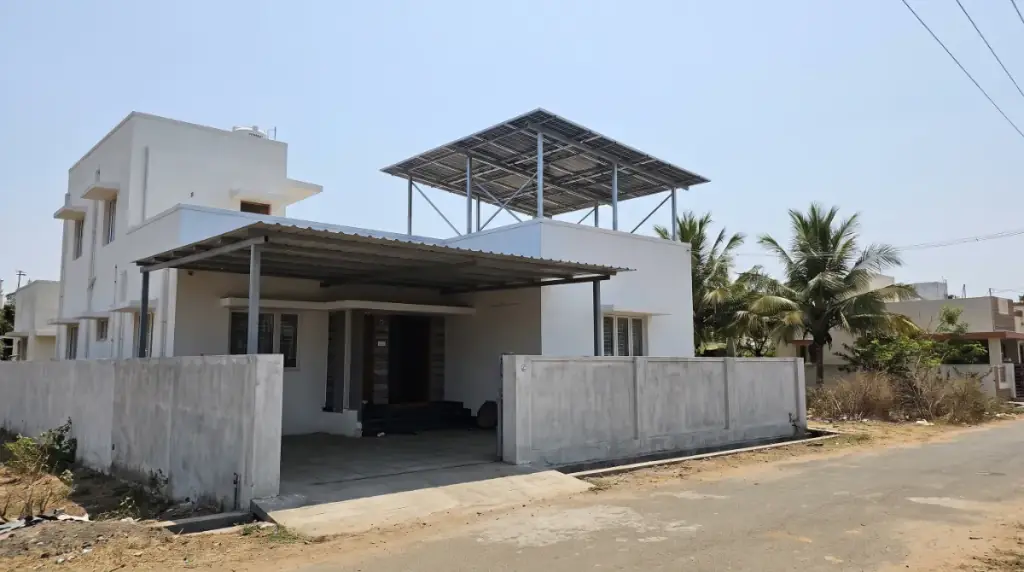 Rooftop solar system on an elevated structure over a modern white villa in Vandalur